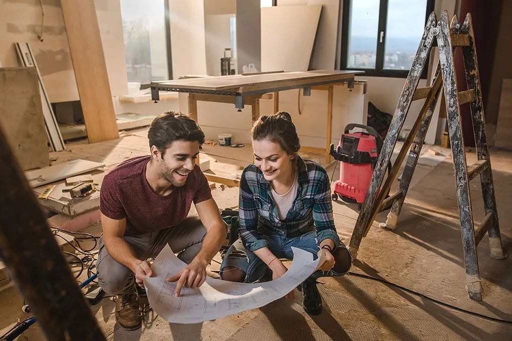 Homeowners reviewing plans in a home ready for renovation